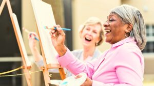 Two people laughing and enjoying an art class together