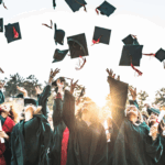 Graduates celebrating graduation by throwing their mortarboards in the air